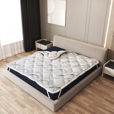 A mattress topper is placed on a bed in a bedroom setting.