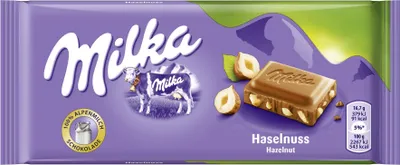 A Milka chocolate bar with hazelnuts on a purple background.