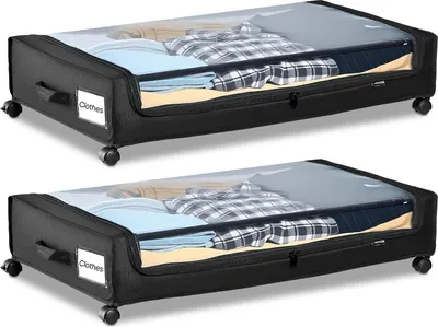 Two identical under-bed storage containers are shown side-by-side against a white background. The containers are black with a clear plastic lid, revealing folded clothes inside. Each container has wheels and handles.