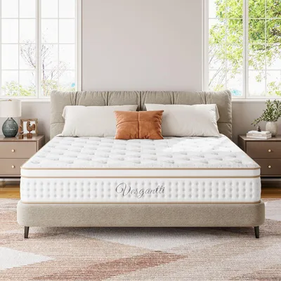 A mattress is displayed on a bed frame in a bedroom setting with windows and nightstands.