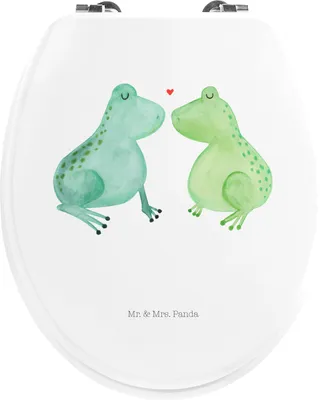 A toilet seat lid with a printed design of two cartoon frogs kissing.