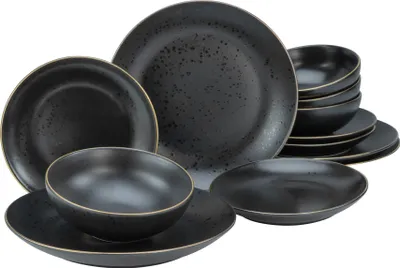 A set of black stoneware plates and bowls with gold trim, arranged on a white background.