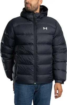 A man wearing a black puffer jacket and blue jeans.