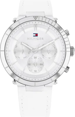 A close-up studio shot of a white Tommy Hilfiger women's watch with a silver-tone case and white leather strap.