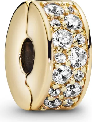A close-up studio shot of a gold charm with clear stones.