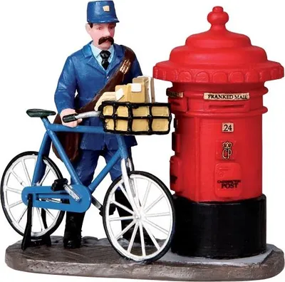 A miniature figurine of a postman with a bicycle and a red post box.