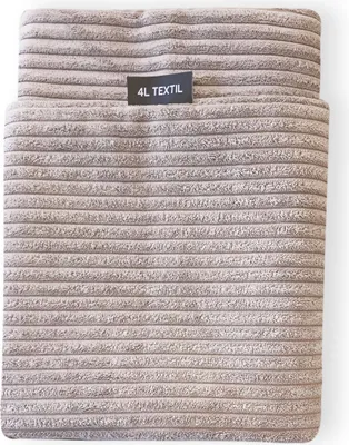 A close-up view of a beige corduroy dog bed cover with a black label.
