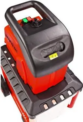 A close-up, slightly angled view of a red and black electric garden shredder.