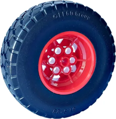 A close-up studio shot of a single LEGO tire with a red rim.