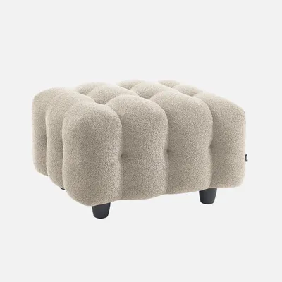 A beige upholstered ottoman with a textured bouclé cover and dark legs, shown against a white background.