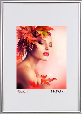 A woman with autumn leaves in her hair, framed by a silver picture frame.