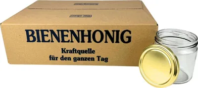 A cardboard box with text and a glass jar with a gold lid are shown against a white background.