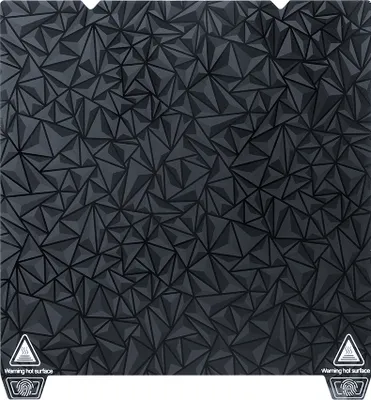 A flat lay of a black 3D printer build plate with a geometric pattern.