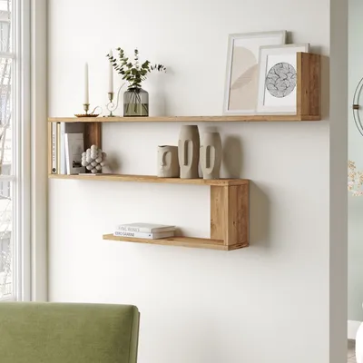 A modern living room with wooden shelves displaying decorative items and books.
