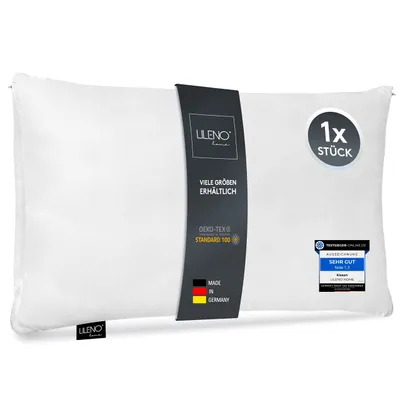 A white pillow with a dark grey band around it containing product information.