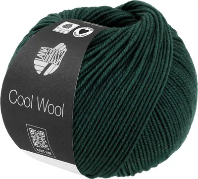 A ball of dark green yarn with a black label wrapped around it.