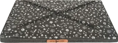 A dog bed with a paw and bone pattern on a white background.