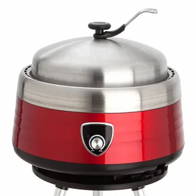 A red and silver multifunctional charcoal grill with a lid and a control knob.