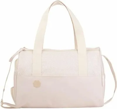 A studio shot of a cream-colored diaper bag with white patterned accents and cream straps.