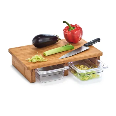 A bamboo cutting board with vegetables and a knife.
