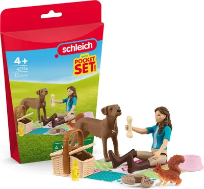 A Schleich Horse Club playset featuring a girl, two dogs, a squirrel, and picnic accessories, displayed with its packaging.