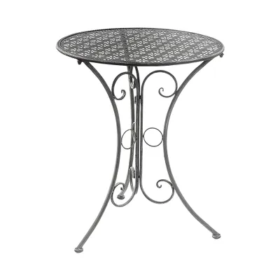 A round metal garden table with an ornate, perforated top and decorative scrollwork on the legs, set against a white background.