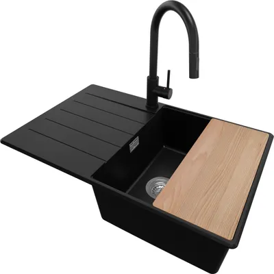 A black kitchen sink with a faucet and a wooden cutting board.