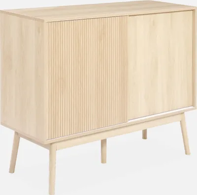 A light wood sideboard with a fluted sliding door and four tapered legs, presented against a white background.