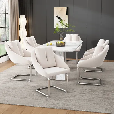 A dining room setting with a marble-topped dining table and six beige upholstered chairs.