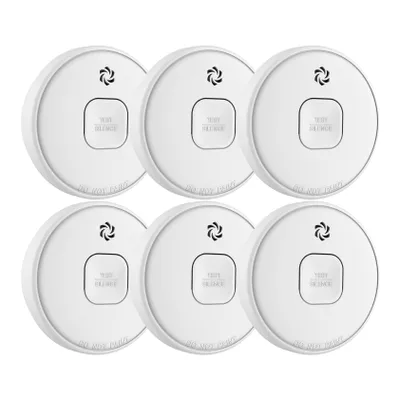 Six white smoke detectors arranged in two rows of three on a white background.
