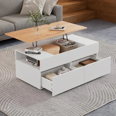 A modern white and wood coffee table with lift-top functionality and storage drawers is shown in a living room setting, placed on a patterned rug next to a grey sofa.
