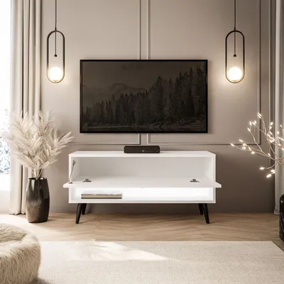 A modern living room with a TV stand, TV, and decorative elements.