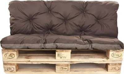 A brown cushion set on a wooden pallet.