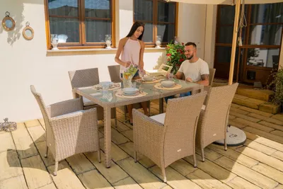 A couple is enjoying a meal at a table on a patio.