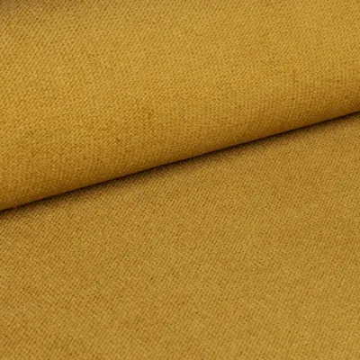 A close-up view of a textured yellow fabric, likely upholstery or textile material.