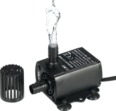 A black submersible water pump with water spraying from its outlet, shown on a white background with a separate filter attachment.