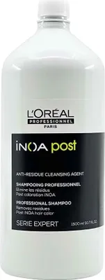 A white bottle of L'Oréal INOA Post-Shampoo is shown against a white background.