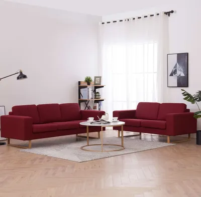 A living room scene with two red sofas and a coffee table.