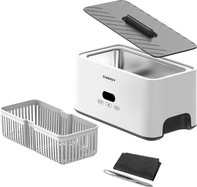 A white ultrasonic cleaner with its accessories laid out on a white background.