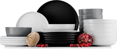 A collection of ceramic dishes in various sizes and colors, including plates and bowls, arranged together.