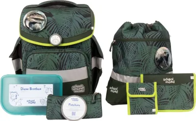 A collection of school supplies with a dinosaur theme, including a backpack, drawstring bag, pencil case, and lunchbox, arranged on a white background.