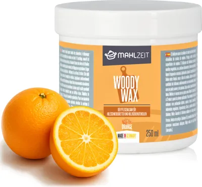 A product shot of a container of wood wax with oranges next to it.