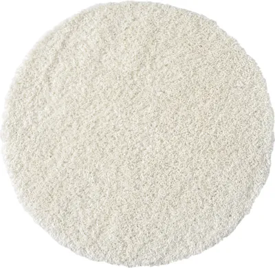 A round, white, high-pile shaggy rug.