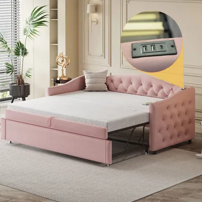 A pink upholstered daybed with an extended mattress, set up in a living room.