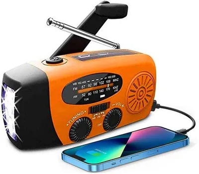 Zdjęcie produktu dla Przenośne radio awaryjne Unyqoos® z korbką i panelem słonecznym, akumulator 2000 mAh, odbiory AM/FM, funkcja ładowania przez USB, dioda LED 1 W + 3 diody LED jako lampka awaryjna, kolor pomarańczowy, kompaktowe, idealne do campingów i aktywności na świeżym powietrzu