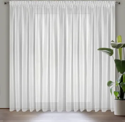 A white sheer curtain hanging in front of a window.