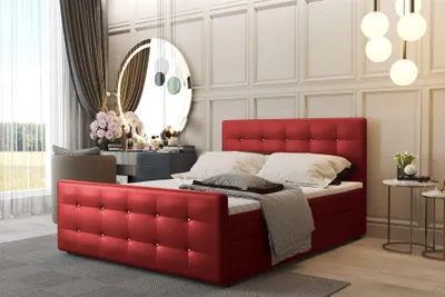 A red upholstered boxspring bed in a bedroom setting.