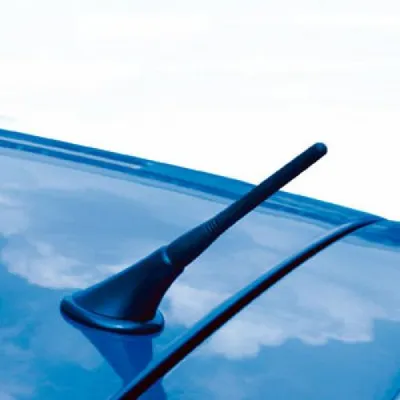 A black car antenna on the roof of a blue car.