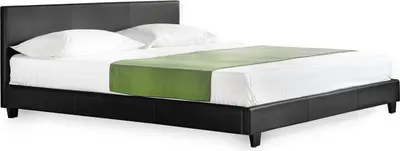 A black leather bed with white bedding and a green runner.
