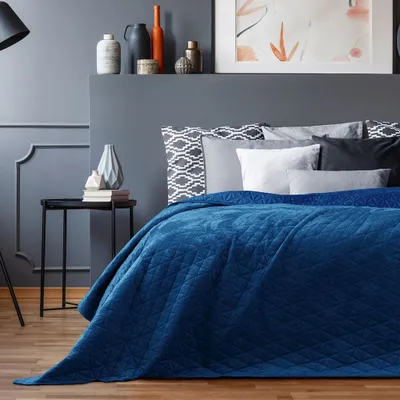 A bedroom scene with a bed, nightstand, and decorative items.